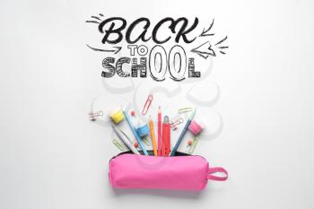 Pencil case with stationery and text BACK TO SCHOOL on white background�