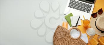 Composition with beach accessories and laptop on light background with space for text�