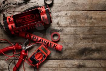 Bomb with tools on wooden background�