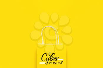Paper shopping bag with text CYBER MONDAY on color background�