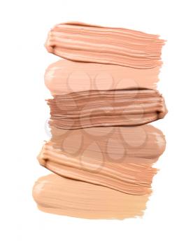 Different samples of foundation for makeup on white background�