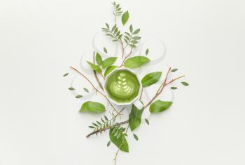 Beautiful composition with cup of matcha tea on white background�