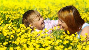 Royalty Free Photo of a Mother and Child in a Field of Flowers