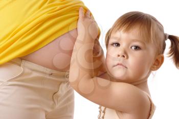 Royalty Free Photo of a Little Girl and a Woman's Pregnant Belly
