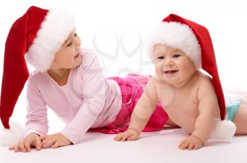 Royalty Free Photo of a Two Children in Santa Hats