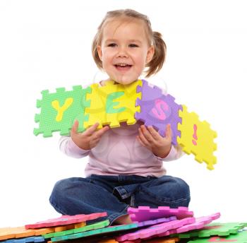 Royalty Free Photo of a Little Girl With a Foam Puzzle