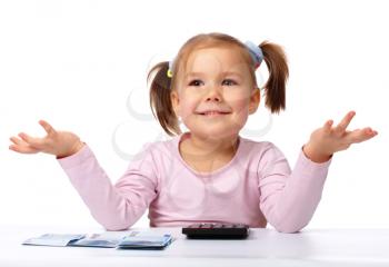 Royalty Free Photo of a Little Girl With Money and a Calculator