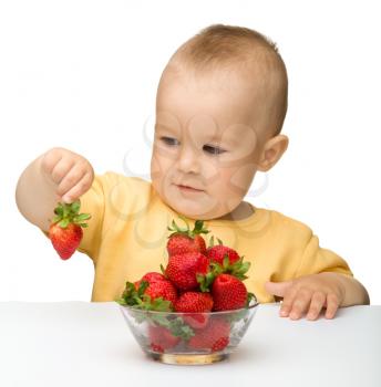 Royalty Free Photo of a Little Boy Eating Strawberries