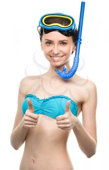 Young happy woman with snorkel equipment and showing thumb up sign using both hands, isolated over white