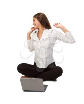 Royalty Free Photo of a Girl Stretching at a Laptop
