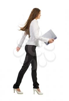 Royalty Free Photo of a Woman Walking With a Laptop