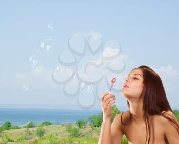 Royalty Free Photo of a Girl Blowing Bubbles