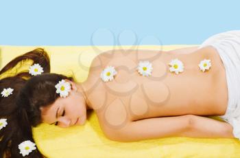 Royalty Free Photo of a Woman Getting a Massage With Daisies