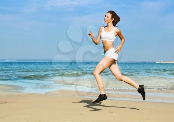 Royalty Free Photo of a Woman Running at the Beach
