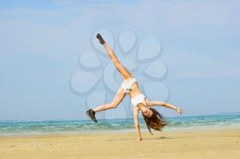 Royalty Free Photo of a Woman Doing Cartwheels