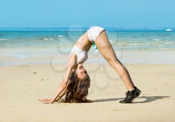 Royalty Free Photo of a Woman Stretching on the Beach