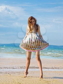 Royalty Free Photo of a Woman in a Short Dress at the Beach