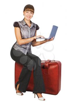Royalty Free Photo of a Woman With a Laptop Sitting on Luggage