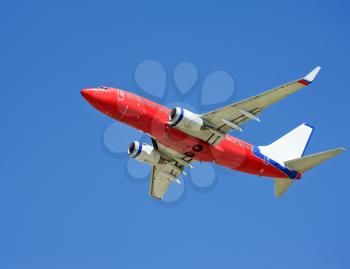 Large passenger plane flying in the blue sky 