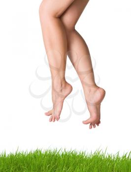 image of smooth,sexy and beautiful female legs over green grass