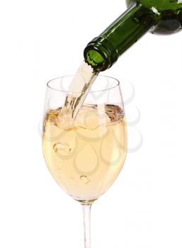 White wine being poured into a wine glass.Isolated on white