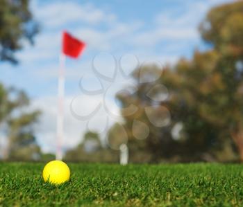 yellow golf ball over green grass outdoors