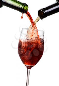 white and red wine  being poured into a wine glass isolated on white

