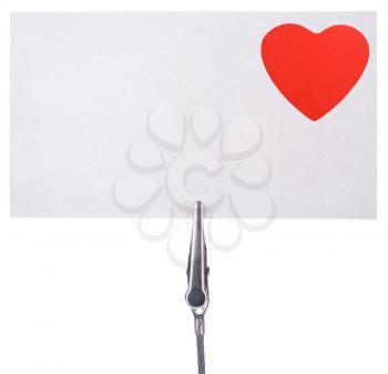 blank card with a red heart attach by a clip  isolated on white background 