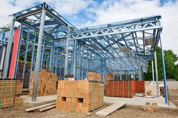 New home under construction using steel frames against a blue sky