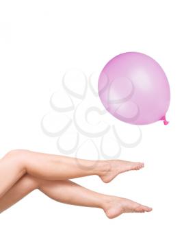smooth and beautiful female legs with pink balloon isolated on white
