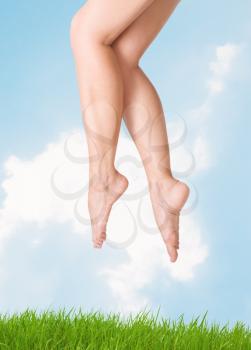 
image of smooth,sexy and beautiful female legs against the sky