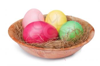 multicolored Easter eggs  in a nest isolated on a white background 
