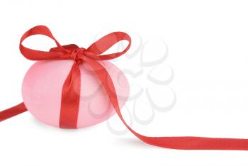 Pink Easter egg with a red ribbon isolated on white background