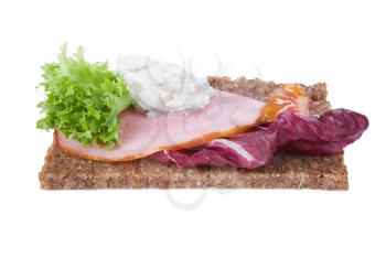 whole grain rye bread sandwich with ham and vegetables isolated on white