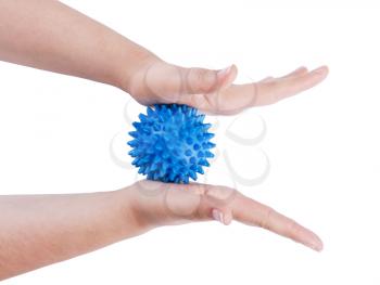 Woman's hands with Spiny plastic blue massage ball isolated on white background