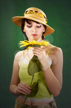 portrait of a beautiful  young woman with sunflower