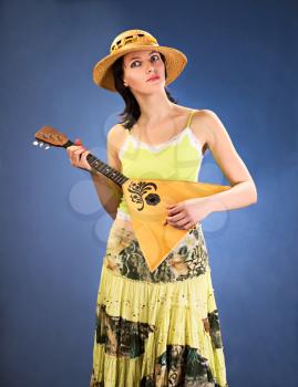 pretty woman with a national russian a stringed instrument in her hands