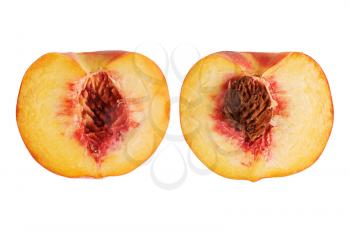 fresh  peach cut in halves with seed  isolated on white