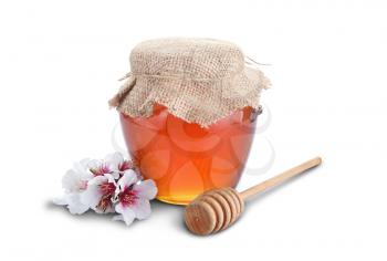 Honey with wood stick and flowers isolated on white background