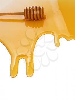 puddle of honey with wooden stick isolated on white background