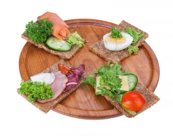 rye bread sandwiches on the wooden plate isolated on white background 
