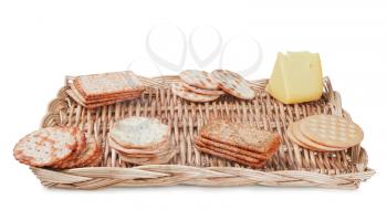 some crackers and cheese on the wicker plate isolated on white background