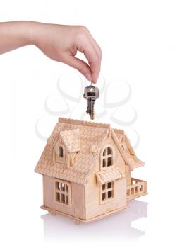 Conceptual image with small house and keys.Isolated on white