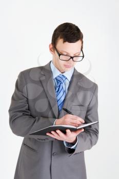 Portrait of handsome young businessman with notebook