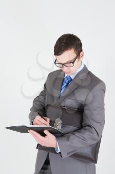Portrait of handsome young businessman with notebook and briefcase