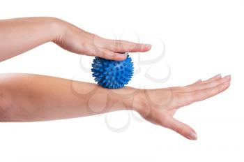Womans hand with Spiny plastic blue massage ball isolated on white