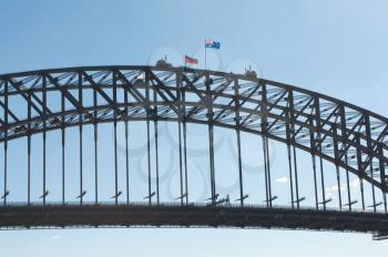 middle part  of the Sydney Harbour Bridge with climbers and flags