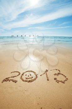 digits 2013 on the sand seashore - concept of new year
