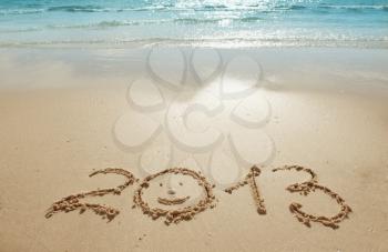 digits 2013 on the sand seashore - concept of new year