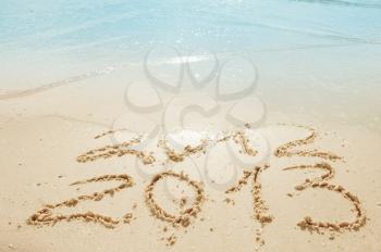 digits  2012 and 2013 on the sand seashore - concept of new year and passing of time